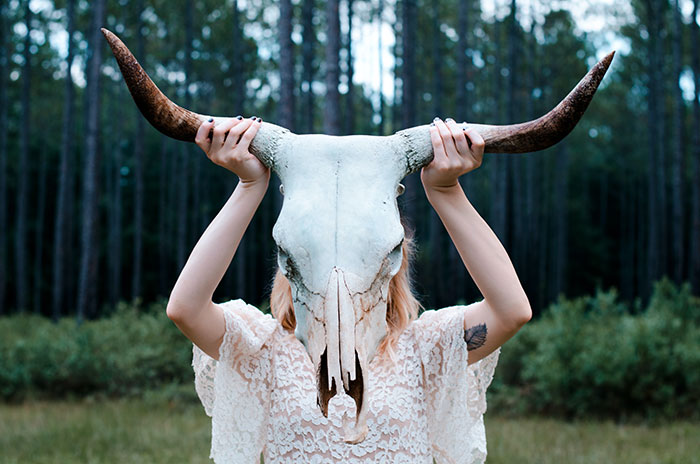 Woman holding animal skull