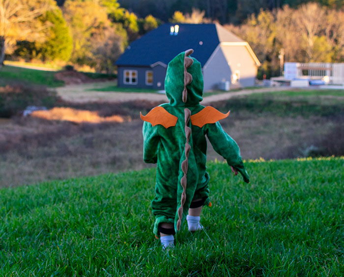 Kid wearing dragon costume