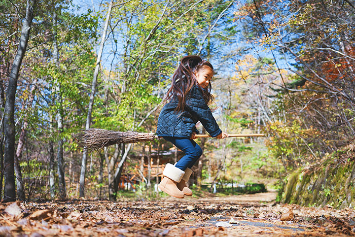 Girl sitting on broomstick