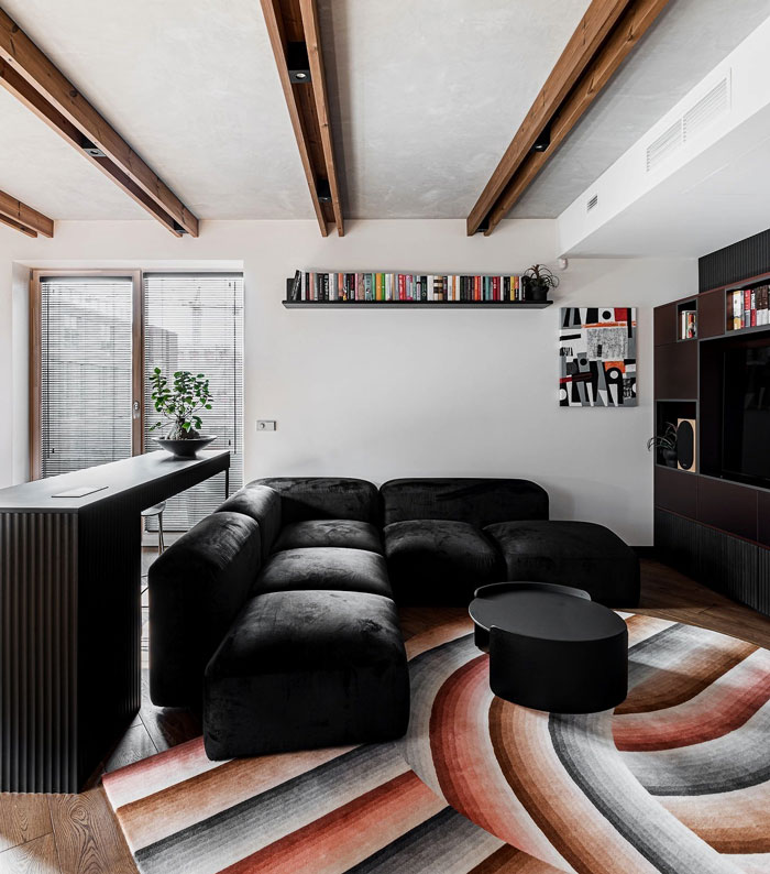 Avant-garde living room featuring a black couch, modern coffee table, and stylish interior design ideas.