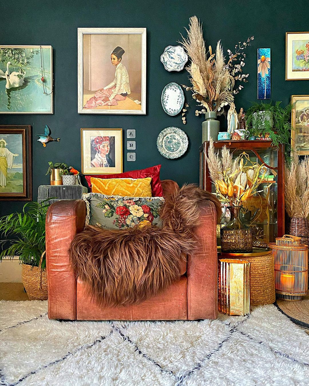 Colorful living room ideas featuring a leather armchair, patterned pillows, wall decorations, and lush plants.