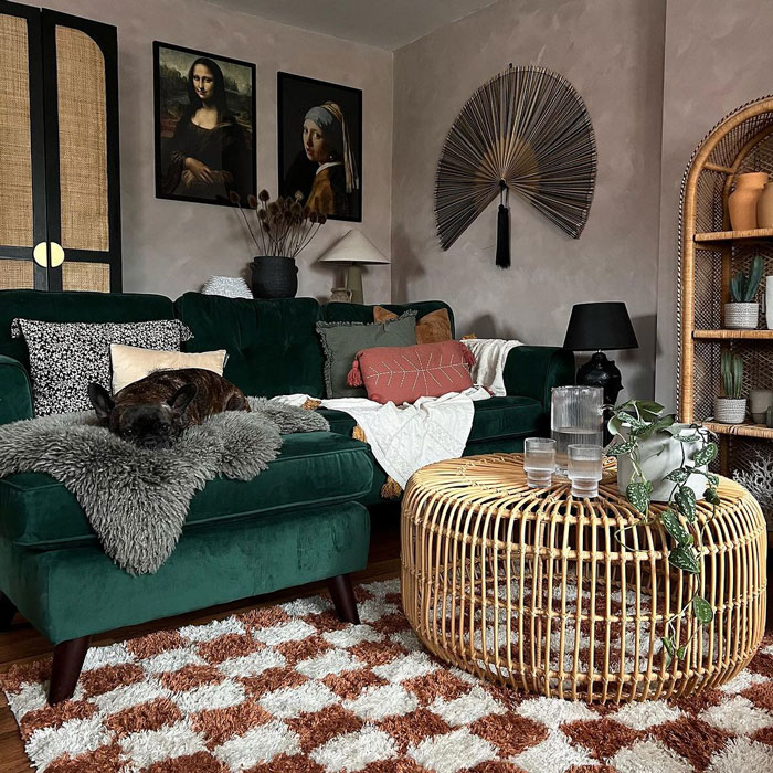 Living room ideas featuring a green velvet couch and round wooden coffee table in a cozy interior setting.