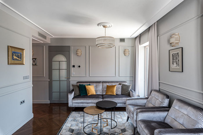 Art Deco living room ideas featuring velvet sofas, geometric rug, and elegant lighting for stylish interior refresh.