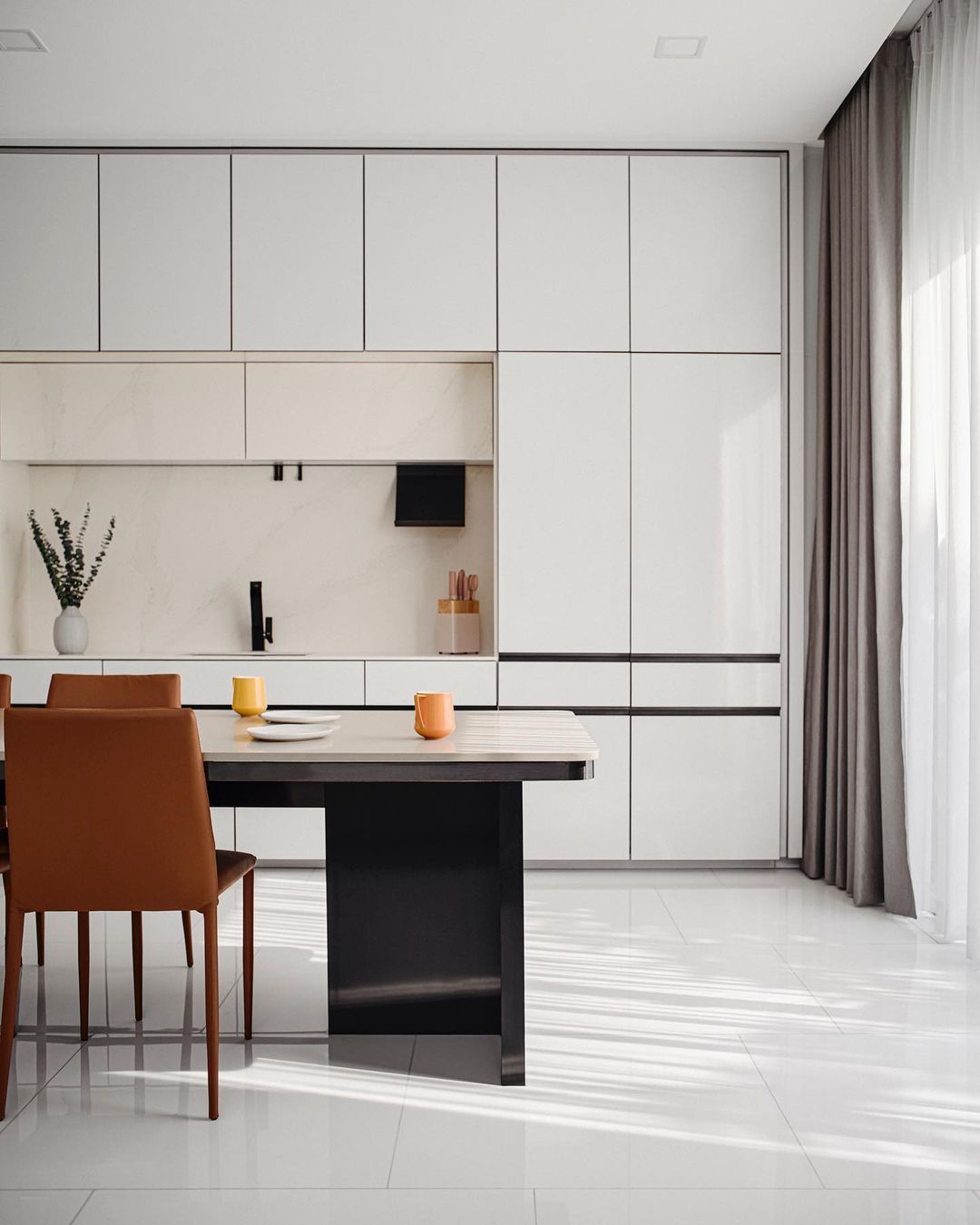 Modern big kitchen with a dining table and orange chairs showcasing living room ideas and interior design insights.