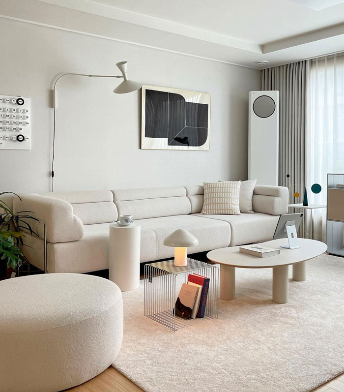 Neutral colored living room featuring a big white couch, modern coffee table, and stylish decor with living room ideas and designer insights.