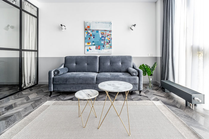 Art Deco living room featuring a gray sofa, marble tables, and designer-inspired interior refresh ideas.