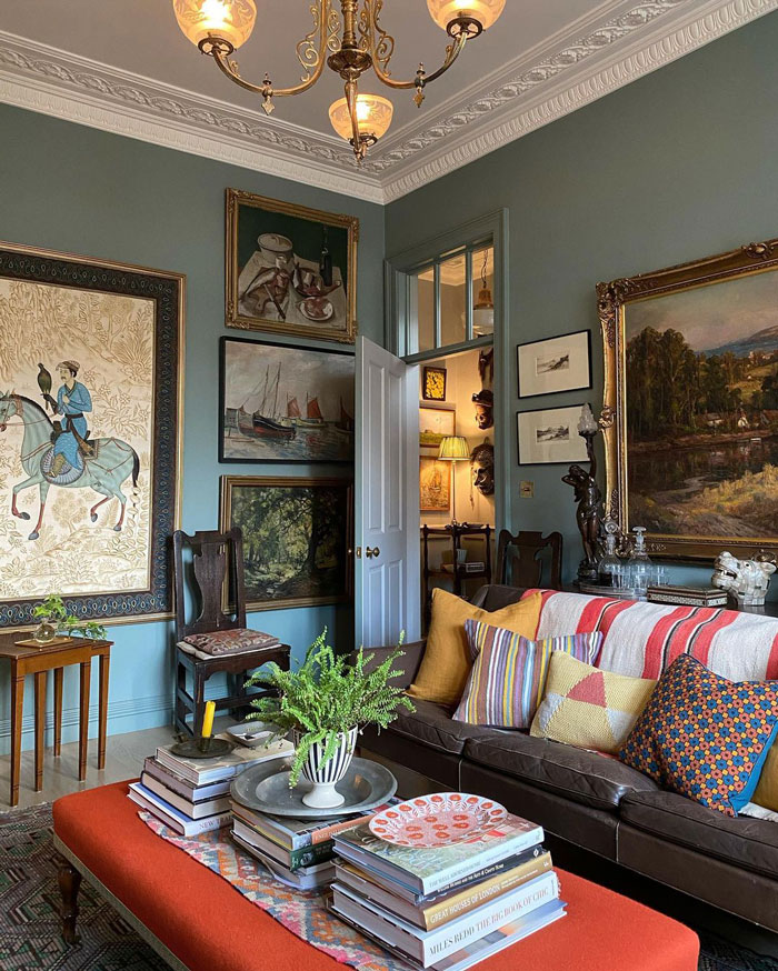 Elegant eclectic living room with vintage style paintings, colorful cushions, and designer insights for refreshing your interior.