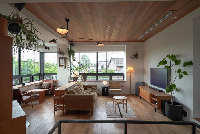 Simple living room interior with wooden ceiling, large windows, cozy seating, and natural light showcasing living room ideas.