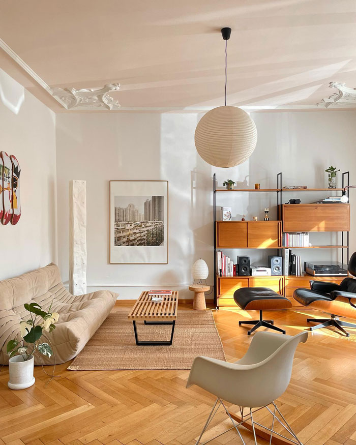 Living room ideas featuring a beige couch, modern shelving, wooden accents, and natural light in a stylish living space.