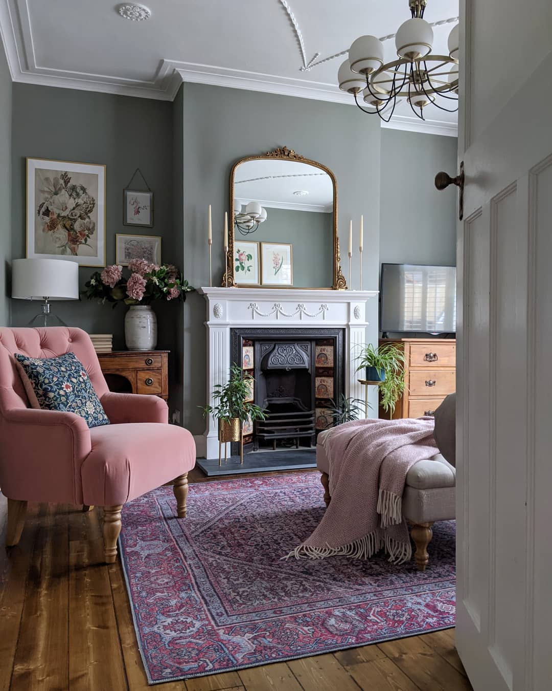 Traditional living room with pink armchair, decorative fireplace, and classic interior design ideas for refresh your interior.