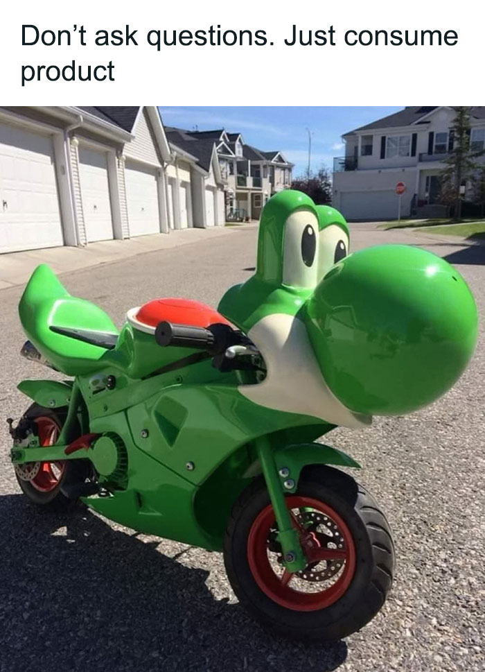 Yoshi-themed motorcycle with humorous text caption in suburban street setting.