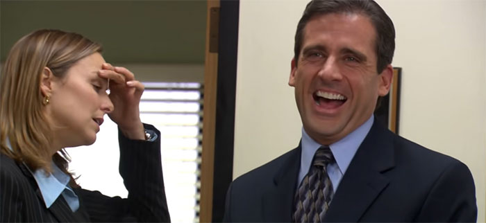 Michael Scott laughing heartily in an office setting, showcasing why he is considered the best boss ever.