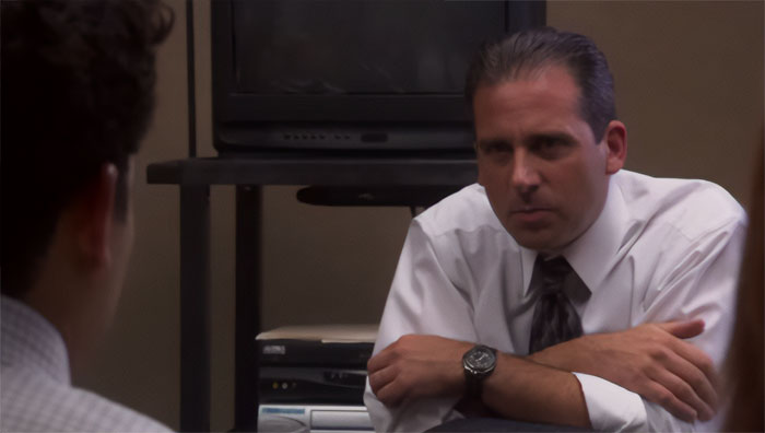 Michael Scott talking seriously in an office setting, exemplifying quotes that prove he’s the best boss ever.