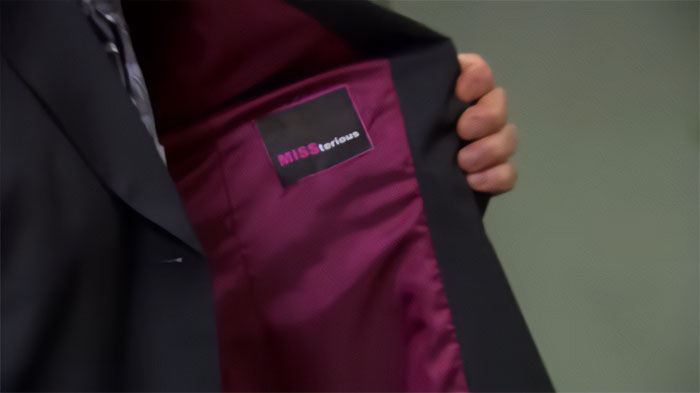Inside view of a black blazer with pink lining, relating to Michael Scott quotes about the best boss ever.