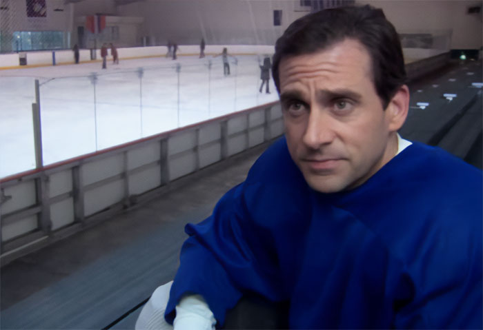 Michael Scott wearing blue gear near an ice rink, showcasing moments from best boss ever Michael Scott quotes.