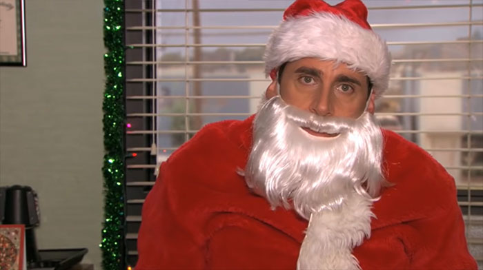 Michael Scott dressed as Santa Claus in an office setting, showcasing his role as the best boss ever.