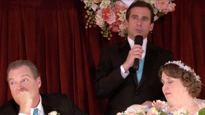 Michael Scott speaking into a microphone at a wedding, showcasing iconic Michael Scott quotes as best boss ever moments.