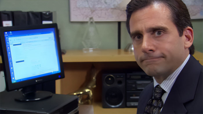 Michael Scott sitting at his office computer, demonstrating iconic quotes from the best boss ever in a workplace setting.