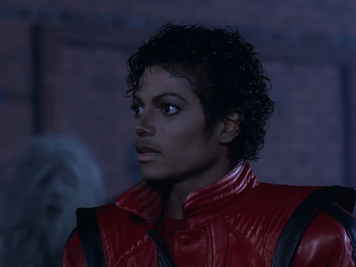Michael Jackson performing Thriller in iconic red jacket, a legendary moment in amazing and bizarre music facts.