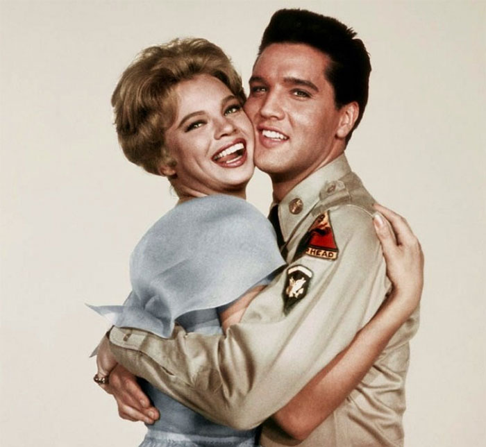 Juliet Prowse and Elvis Presley smiling in a warm embrace, vintage portrait related to amazing music facts.