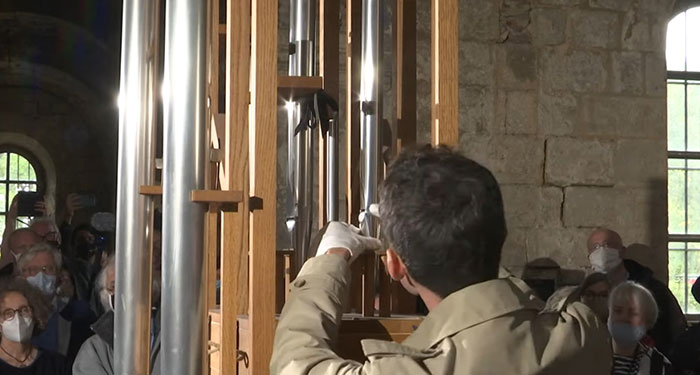 Person operating an automated organ performing an avant-garde piece, illustrating bizarre music facts to soothe your ears.