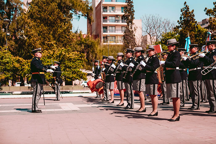 Military orchestra performing a live piece, showcasing amazing music facts in a formal outdoor setting.