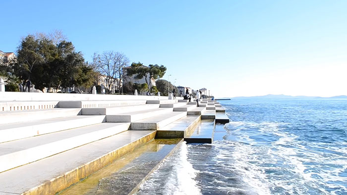 Sea organ on a coastal promenade creating soothing music with ocean waves, illustrating amazing and bizarre music facts.