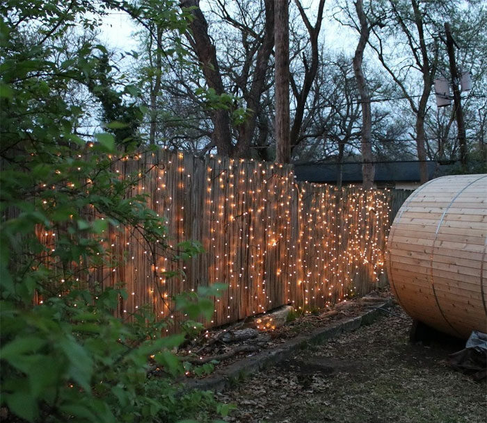 String fairy lights on the brown fence String fairy lights on the brown fence