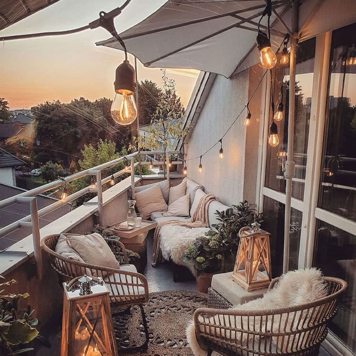 Balcony with furniture white sheets pillows and led lights Balcony with furniture white sheets pillows and led lights