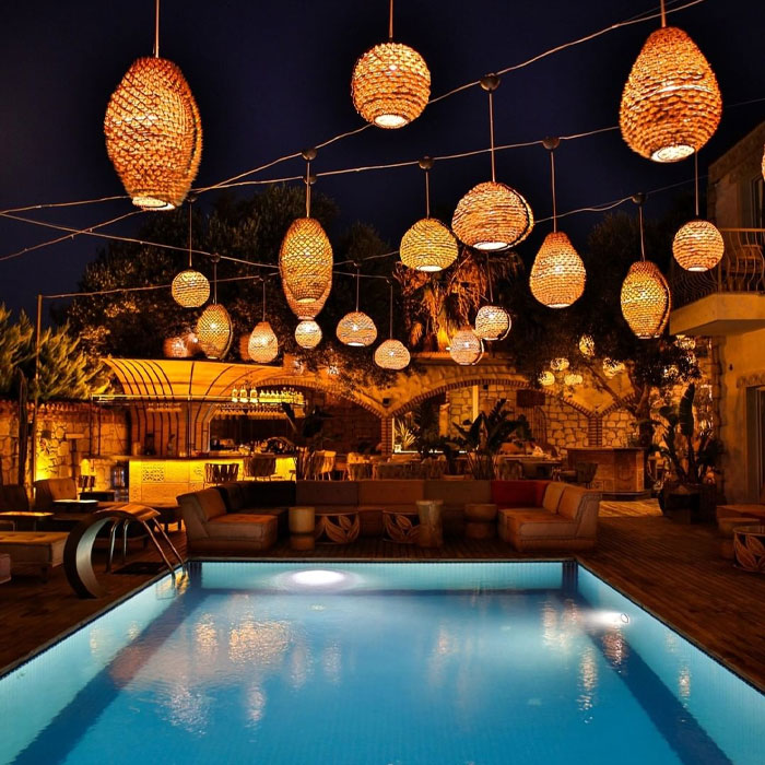 Backyard with furnitures pool and hanging lanterns Backyard with furnitures pool and hanging lanterns