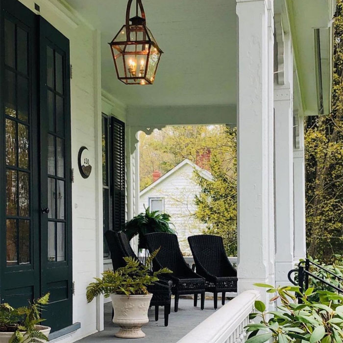 Porch with black furniture flowers and pendant light Porch with black furniture flowers and pendant light