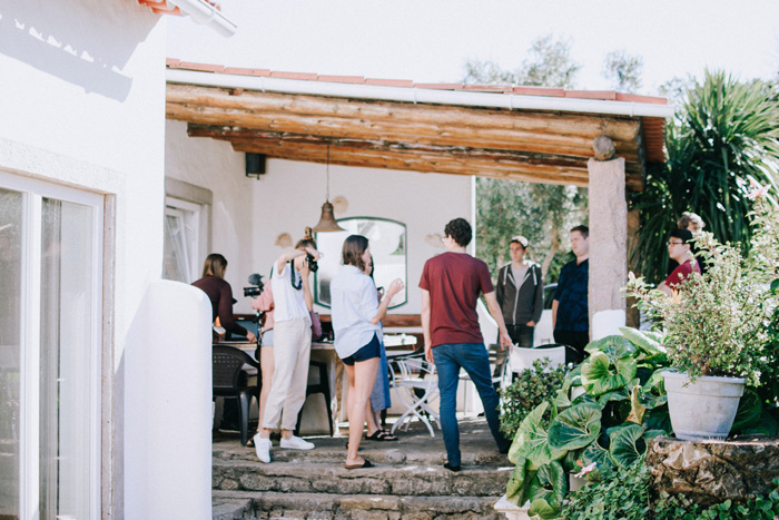 Wooden deck pergola on a patio with people gathering, showcasing backyard pergola ideas for a stunning outdoor space.
