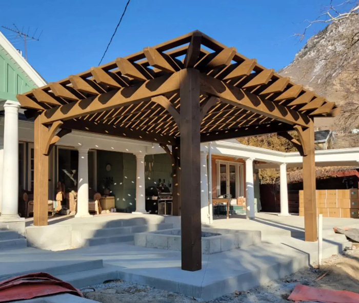Wooden attached pergola on a patio providing stylish shade, enhancing outdoor living space and backyard aesthetic.