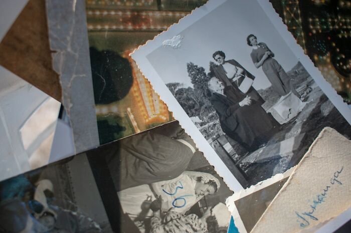 Stack of vintage black and white photos representing memories that eventually disappeared without anyone noticing.