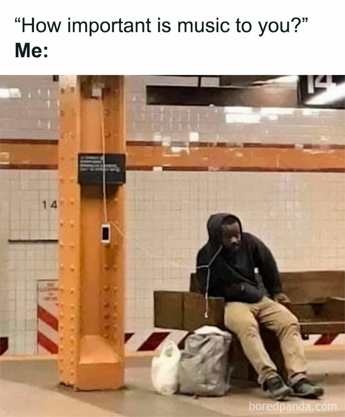 A person in a subway station charging their phone, listening to music, illustrating a meme about the significance of music in life.