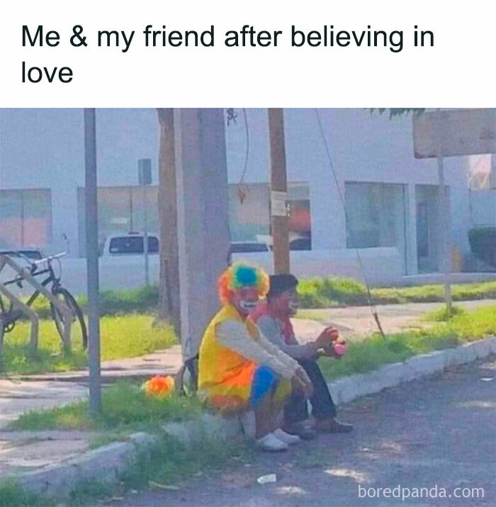 Two people sitting on the curb, one dressed as a clown, humorously depicting memes about life.