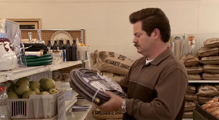 Ron Swanson shopping at Food and Stuff store, embodying iconic Ron Swanson quotes on life and simplicity.