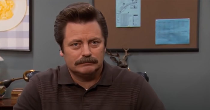 Ron Swanson looking straight ahead with a serious expression, representing iconic Ron Swanson quotes on life.
