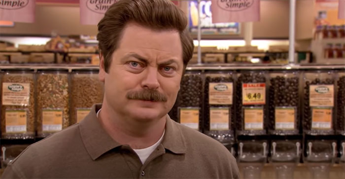 Ron Swanson standing in a vegan grocery store, with a serious expression, illustrating Ron Swanson quotes on life.