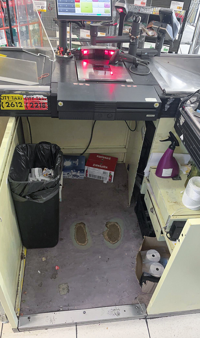 The Wear From The Cashier's Shoes At This Shop's Checkout