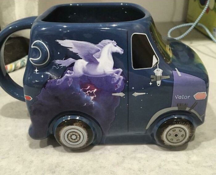 Dark blue novelty mug shaped like a van with a winged horse and night sky design, showcasing creative mug life art.