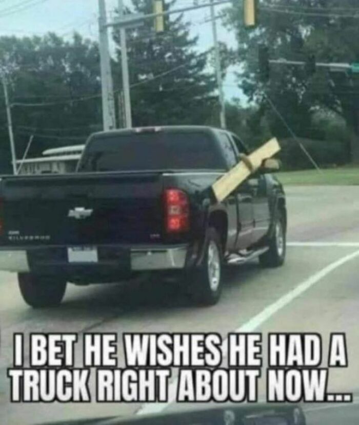 A wood plank awkwardly hanging from the back of a truck; funny pic highlighting driver’s dilemma.