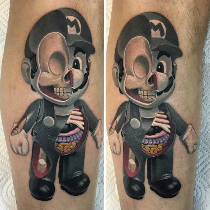 Video game tattoo of Mario with black hat and exposed skeleton on leg.