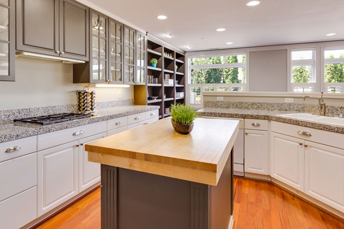 white and gray kitchen with butcher block kitchen island in the middle white and gray kitchen with butcher block kitchen island in the middle