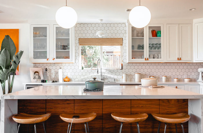 four brown bar chairs under a marble kitchen island four brown bar chairs under a marble kitchen island