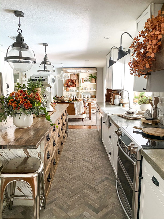 cozy kitchen with wooden kitchen island and autumn inspired decorations cozy kitchen with wooden kitchen island and autumn inspired decorations