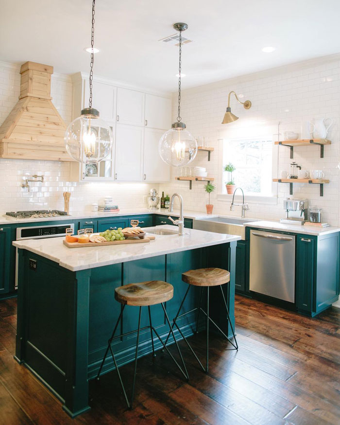 a kitchen with a dark green kitchen island with bar chairs a kitchen with a dark green kitchen island with bar chairs