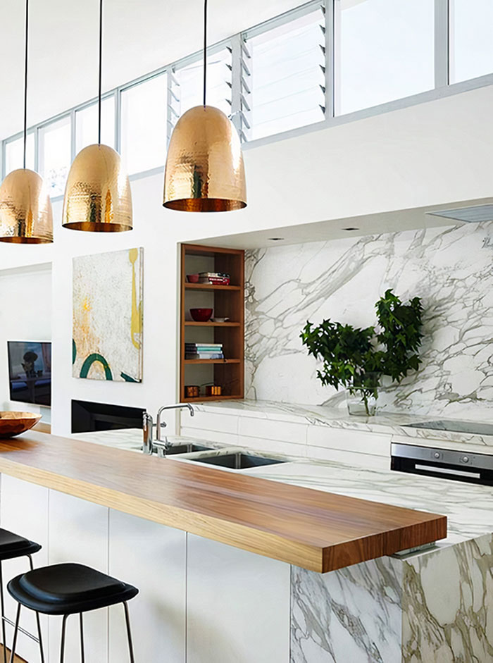 a kitchen with a mixed marble and wood kitchen island a kitchen with a mixed marble and wood kitchen island