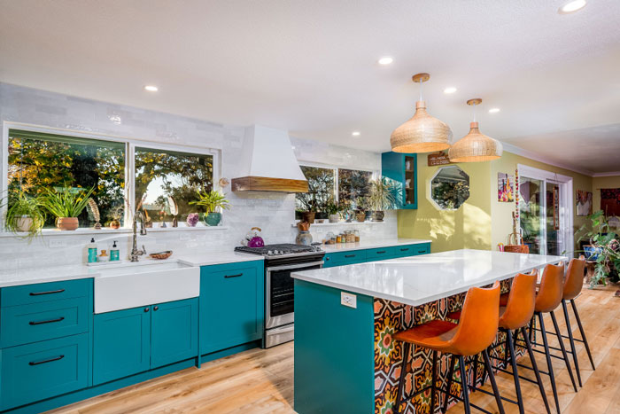 kitchen with blue cabinets and blue and ornamental galley kitchen island with orange bar chairs beside kitchen with blue cabinets and blue and ornamental galley kitchen island with orange bar chairs beside