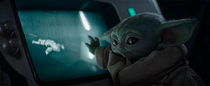 Baby Yoda looking through the glass